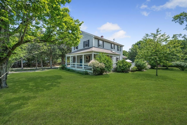 4 Cooks Ln, Westhampton, NY 11977 - rear view of property featuring a lawn, a chimney, and covered porch