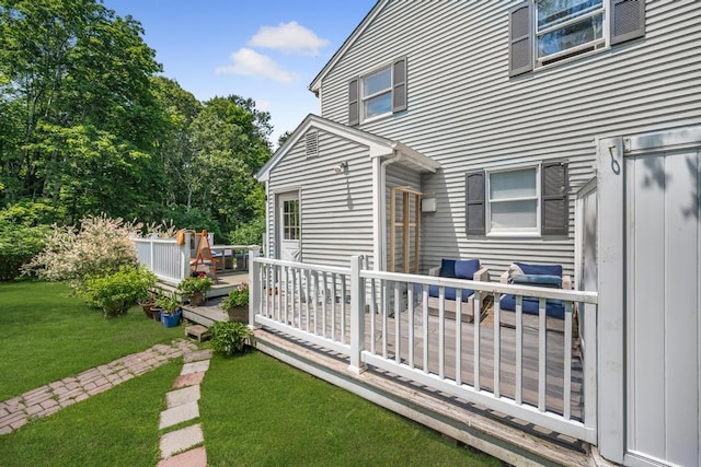 4 Cooks Ln, Westhampton, NY 11977 - back of property featuring a deck and a lawn