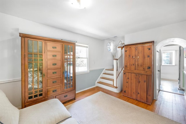 4 Cooks Ln, Westhampton, NY 11977 - entrance foyer with arched walkways, wood finished floors, and stairway