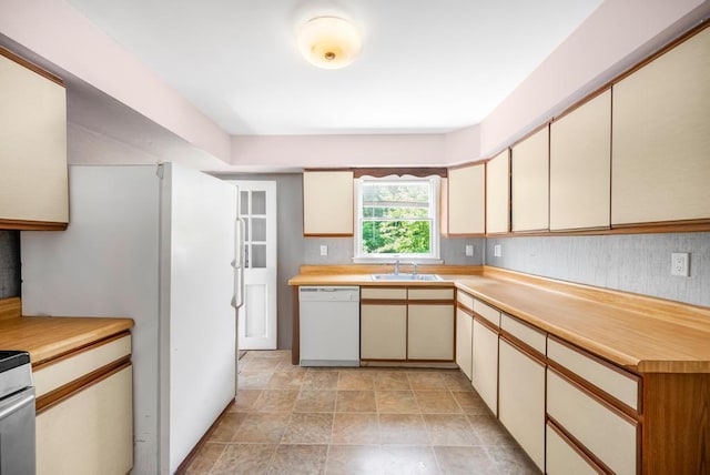 4 Cooks Ln, Westhampton, NY 11977 - kitchen featuring white dishwasher, cream cabinetry, light countertops, and stone finish floors