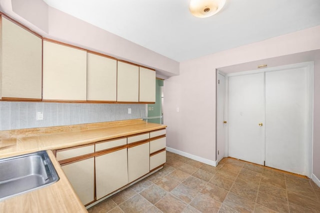 4 Cooks Ln, Westhampton, NY 11977 - kitchen featuring cream cabinetry, light countertops, and stone finish flooring