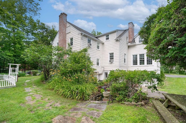 1146 N Ave, New Rochelle, NY 10804 - back of property featuring a chimney and a lawn