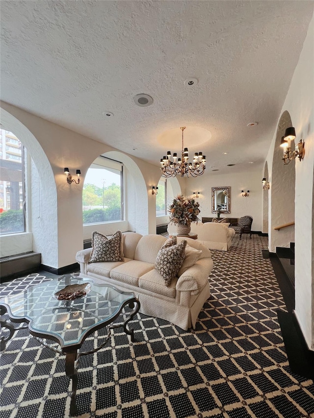 1815 215th St Unit 1G, Flushing, NY 11360 - living room with a textured ceiling, a chandelier, arched walkways, stairway, and carpet flooring
