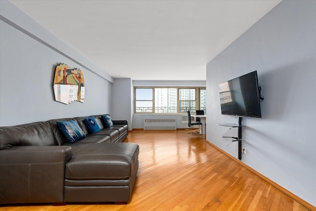 2928 W 5th St Unit 10P, Brooklyn, NY 11224 - living room with radiator heating unit and light wood-style floors