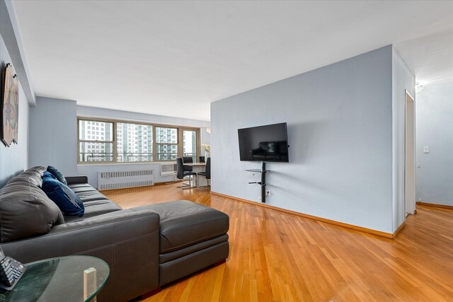 2928 W 5th St Unit 10P, Brooklyn, NY 11224 - living room with radiator and wood finished floors