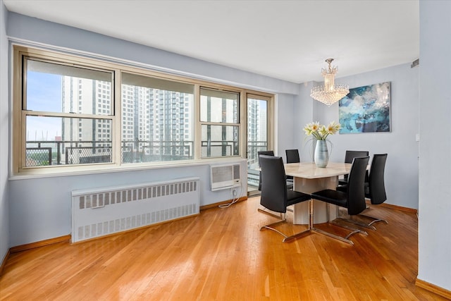 2928 W 5th St Unit 10P, Brooklyn, NY 11224 - dining space featuring radiator, a chandelier, wood finished floors, and an AC wall unit