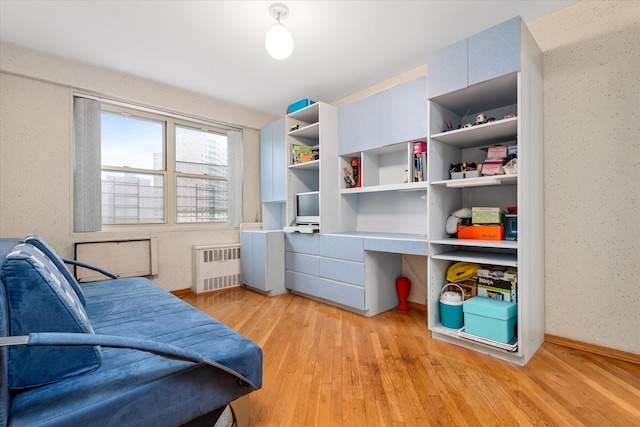 2928 W 5th St Unit 10P, Brooklyn, NY 11224 - bedroom featuring radiator, light wood-type flooring, and a desk