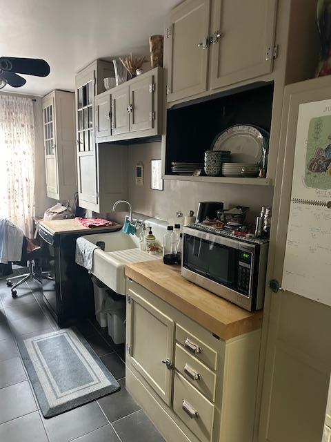 240 Alpine Pl Unit 2A, Eastchester, NY 10707 - kitchen with stainless steel microwave, wooden counters, a ceiling fan, and tile patterned flooring