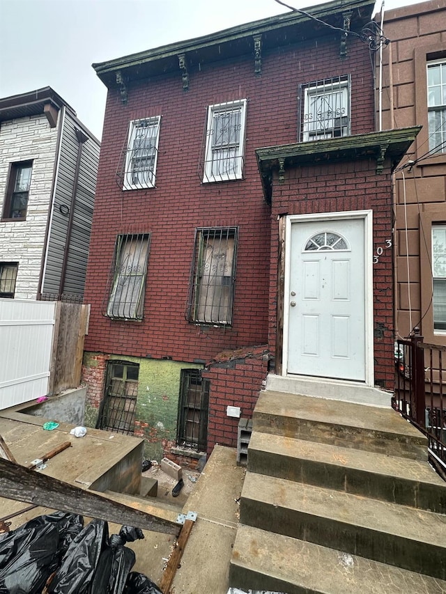 303 Hendrix St, Brooklyn, NY 11207 - view of front facade with brick siding and entry steps