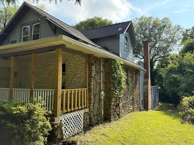 270 N Highland Ave, Pearl River, NY 10965 - view of property exterior featuring stone siding, a yard, covered porch, and a chimney