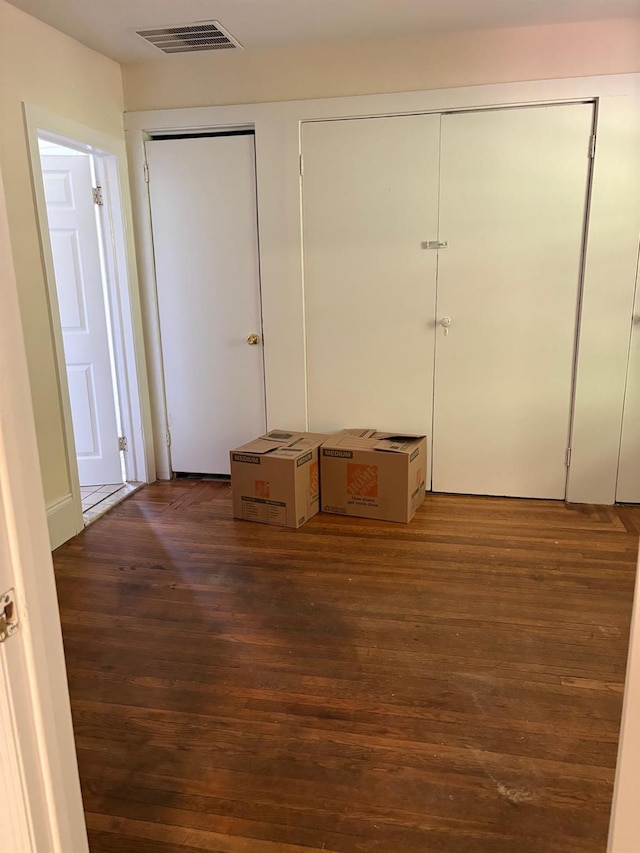 270 N Highland Ave, Pearl River, NY 10965 - unfurnished bedroom featuring multiple closets and dark wood-style flooring