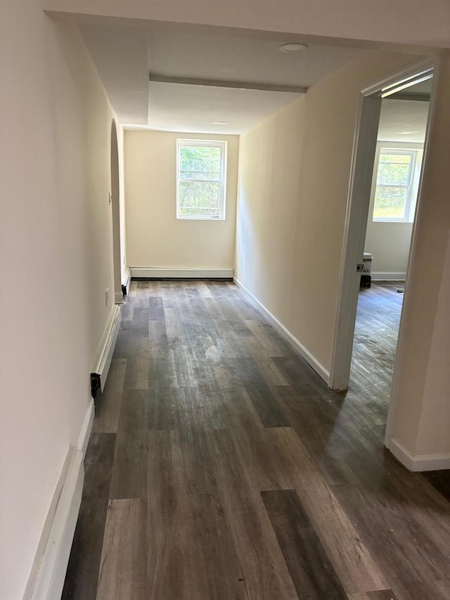 270 N Highland Ave, Pearl River, NY 10965 - hall with a baseboard heating unit, dark wood-style floors, healthy amount of natural light, and arched walkways