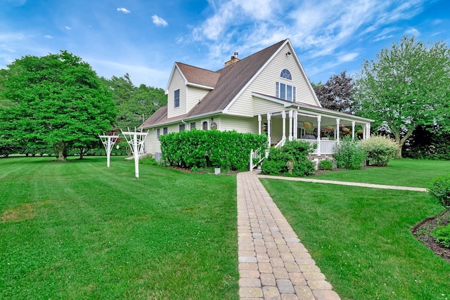 600 Shipyard Ln, East Marion, NY 11939 - view of home's exterior featuring a porch, a lawn, a chimney, and a shingled roof