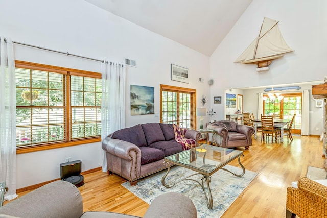 600 Shipyard Ln, East Marion, NY 11939 - living room featuring high vaulted ceiling, wood finished floors, and a chandelier