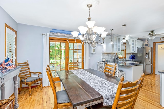 600 Shipyard Ln, East Marion, NY 11939 - dining room featuring a chandelier, light wood-type flooring, and a ceiling fan