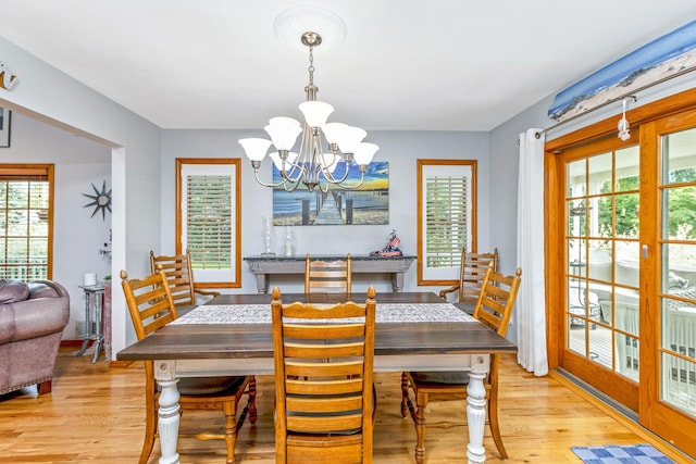 600 Shipyard Ln, East Marion, NY 11939 - dining area with a chandelier and light wood-style floors