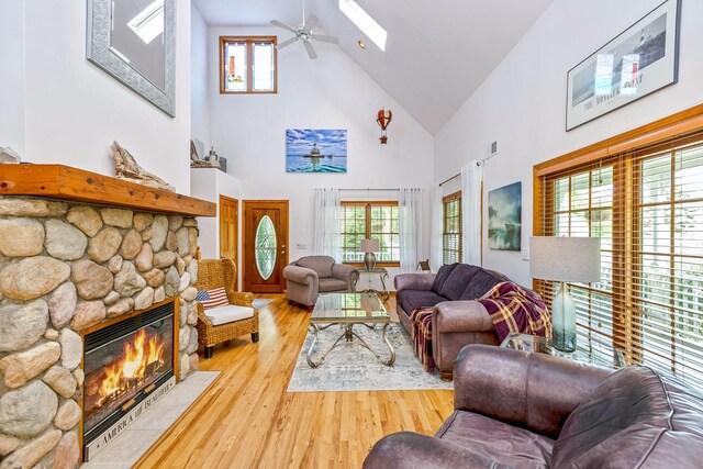 600 Shipyard Ln, East Marion, NY 11939 - living room featuring high vaulted ceiling, wood finished floors, a fireplace, ceiling fan, and a skylight