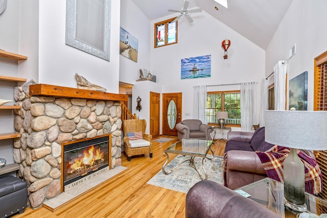 600 Shipyard Ln, East Marion, NY 11939 - living area with high vaulted ceiling, a fireplace, a ceiling fan, wood finished floors, and healthy amount of natural light