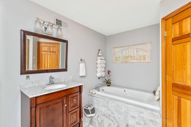 600 Shipyard Ln, East Marion, NY 11939 - bathroom with vanity, a garden tub, and marble finish flooring