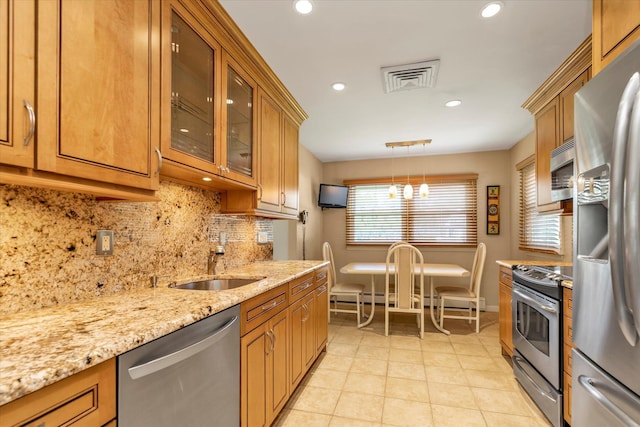 790 Adams St, Baldwin, NY 11510 - kitchen featuring stainless steel appliances, brown cabinets, backsplash, recessed lighting, and light stone countertops