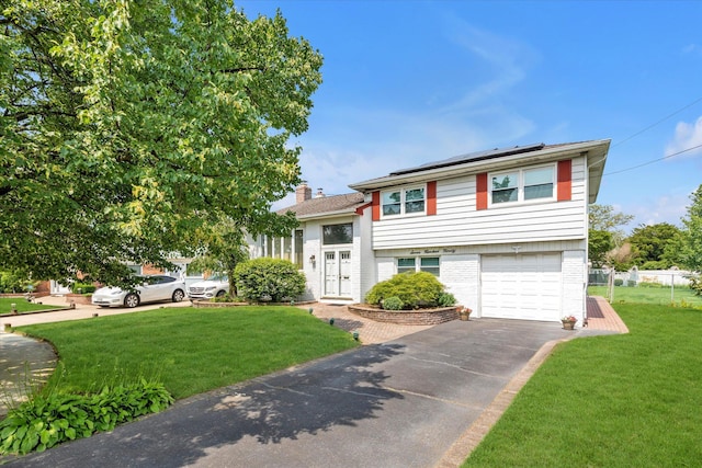 790 Adams St, Baldwin, NY 11510 - tri-level home featuring roof mounted solar panels, asphalt driveway, brick siding, and a garage