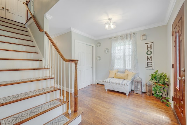 5 Fox Rd, Middle Island, NY 11953 - entryway with stairs, wood finished floors, crown molding, and a baseboard radiator