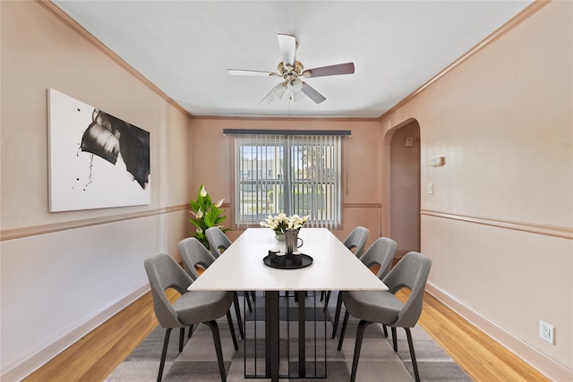 313 Concord Rd, Yonkers, NY 10710 - dining area with arched walkways, a ceiling fan, wood finished floors, and crown molding