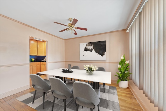 313 Concord Rd, Yonkers, NY 10710 - dining room with light wood-style flooring, a ceiling fan, and crown molding