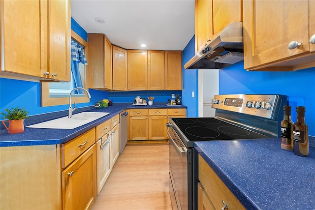 313 Concord Rd, Yonkers, NY 10710 - kitchen featuring appliances with stainless steel finishes, under cabinet range hood, light wood-style floors, and dark countertops