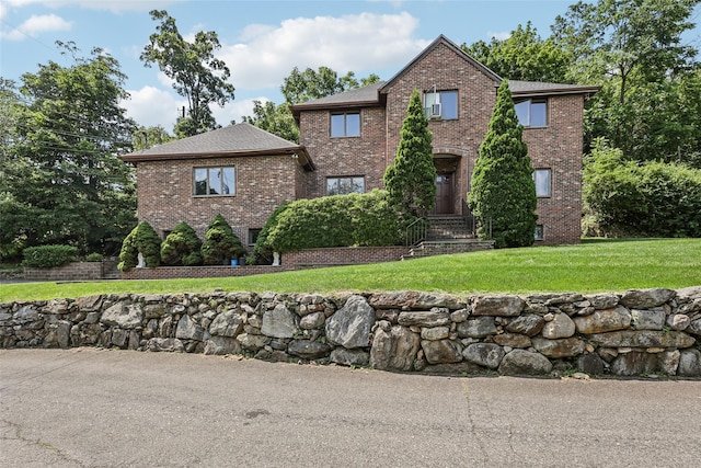 1 Thomas Ct, Scarsdale, NY 10583 - traditional-style home with brick siding, a front lawn, and a shingled roof
