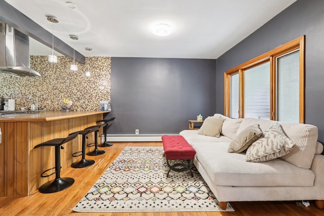 28 Nob Hill Rd, New City, NY 10956 - living room with baseboard heating, wet bar, and wood finished floors