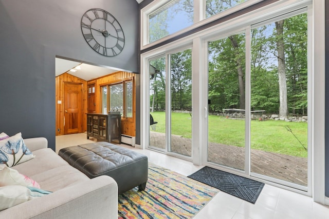 28 Nob Hill Rd, New City, NY 10956 - living area with a baseboard radiator, wooden walls, a towering ceiling, and tile patterned floors