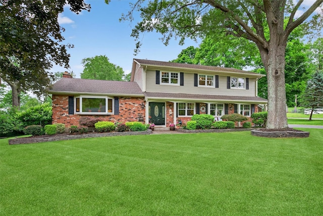 19 Ridgeview Ter, Goshen, NY 10924 - traditional-style house with a chimney, a front lawn, and brick siding