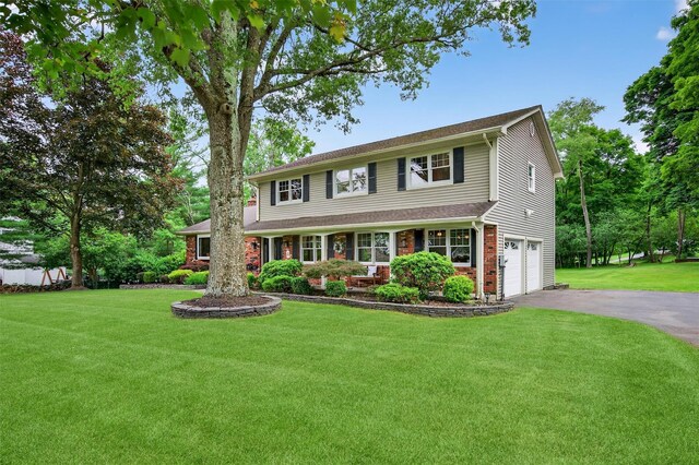 19 Ridgeview Ter, Goshen, NY 10924 - view of front of house featuring driveway, a garage, a front yard, and brick siding
