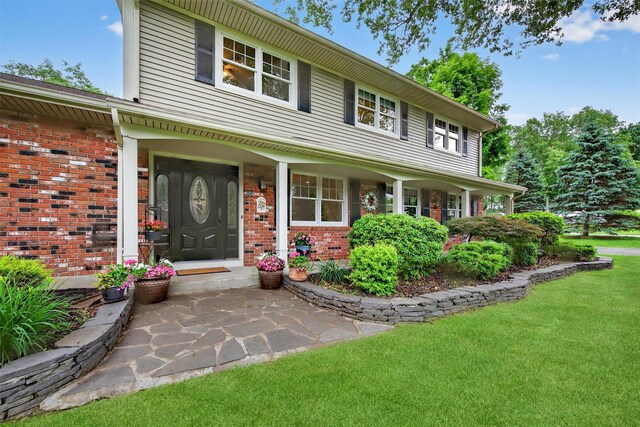 19 Ridgeview Ter, Goshen, NY 10924 - view of front facade featuring brick siding, a front lawn, and covered porch