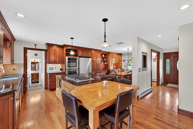 19 Ridgeview Ter, Goshen, NY 10924 - kitchen featuring appliances with stainless steel finishes, a baseboard heating unit, light wood finished floors, recessed lighting, and tasteful backsplash