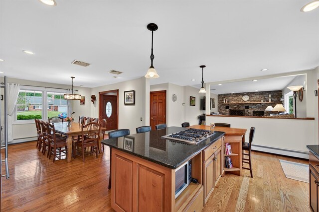 19 Ridgeview Ter, Goshen, NY 10924 - kitchen featuring a baseboard heating unit, appliances with stainless steel finishes, light wood finished floors, a center island, and recessed lighting