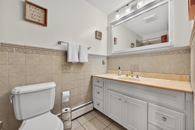 19 Ridgeview Ter, Goshen, NY 10924 - bathroom with tile walls, vanity, tile patterned floors, a baseboard heating unit, and wainscoting