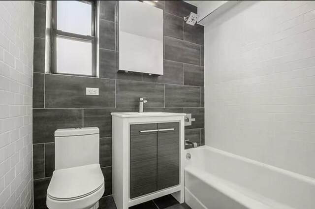 97-25 64th Ave Unit 5D, Rego Park, NY 11374 - full bath featuring tile walls, vanity, and shower / tub combination