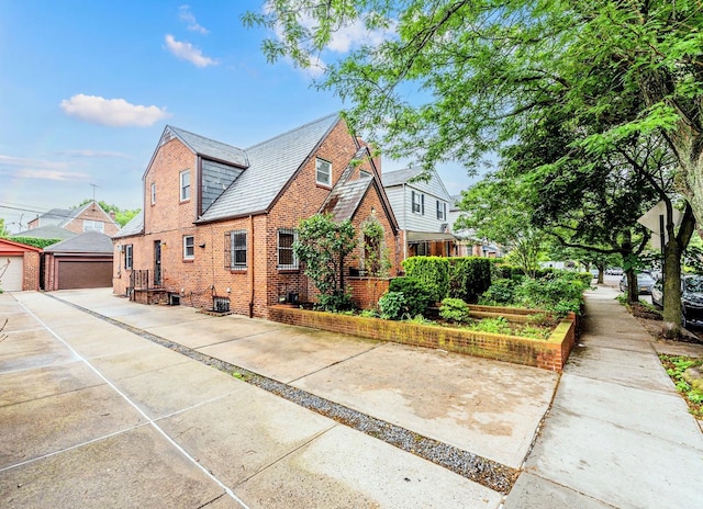 6419 Fitchett St, Rego Park, NY 11374 - view of front of property with brick siding, an outdoor structure, a high end roof, and a detached garage