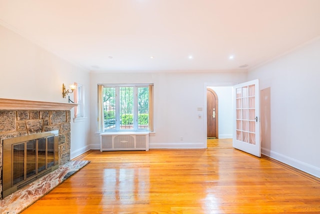 6419 Fitchett St, Rego Park, NY 11374 - unfurnished living room with radiator heating unit, a fireplace, light wood-style floors, and ornamental molding