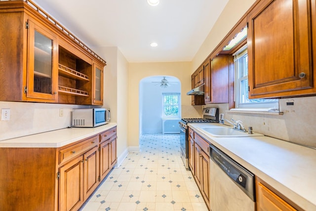 6419 Fitchett St, Rego Park, NY 11374 - kitchen featuring stainless steel appliances, light countertops, a ceiling fan, under cabinet range hood, and glass insert cabinets
