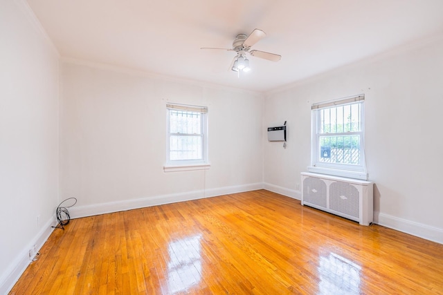 6419 Fitchett St, Rego Park, NY 11374 - spare room featuring radiator, plenty of natural light, ceiling fan, ornamental molding, and wood finished floors