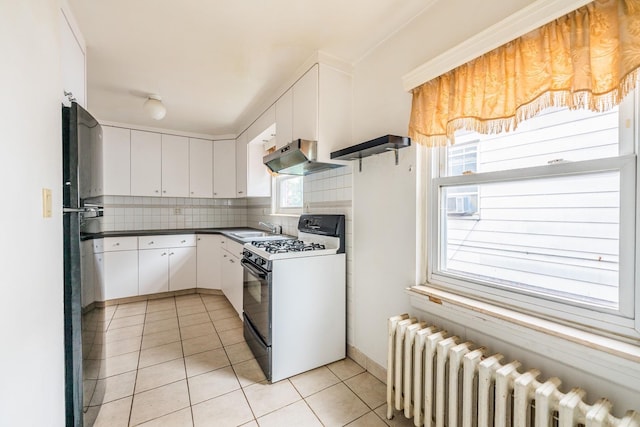 6419 Fitchett St, Rego Park, NY 11374 - kitchen featuring white range with gas cooktop, radiator heating unit, extractor fan, light tile patterned flooring, and backsplash