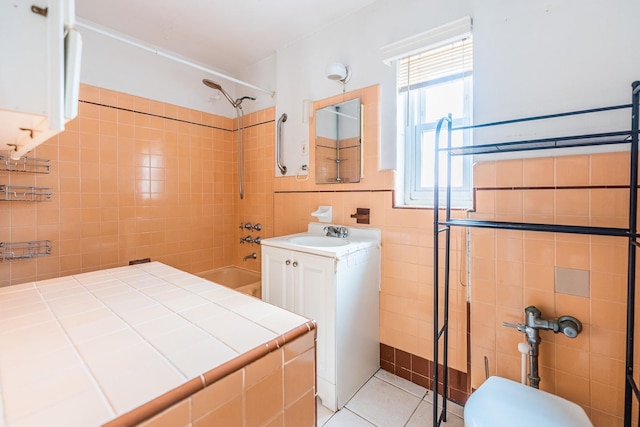 6419 Fitchett St, Rego Park, NY 11374 - full bathroom featuring tile walls, vanity, shower / bathtub combination, and tile patterned floors