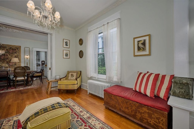 111 S Hamilton St, Poughkeepsie, NY 12601 - living area featuring radiator, ornamental molding, a chandelier, and hardwood / wood-style flooring