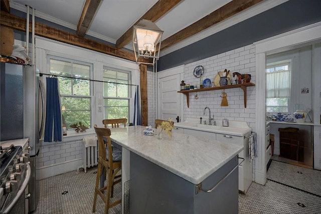 111 S Hamilton St, Poughkeepsie, NY 12601 - kitchen with stainless steel gas range oven, open shelves, beam ceiling, a kitchen breakfast bar, and a kitchen island