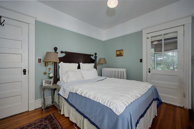 111 S Hamilton St, Poughkeepsie, NY 12601 - bedroom featuring radiator heating unit, dark wood-type flooring, and access to exterior