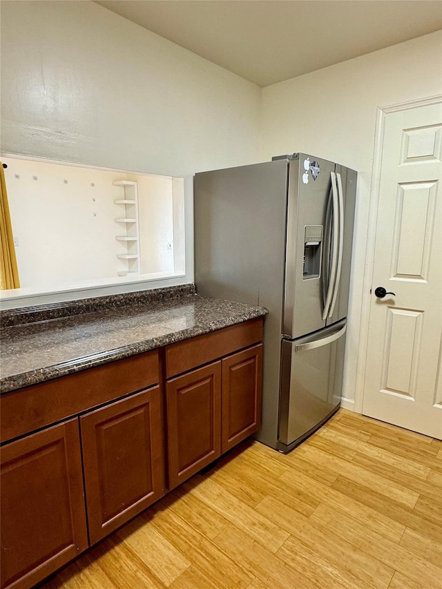 324 Concord Ln, Middletown, NY 10940 - kitchen with stainless steel fridge, dark countertops, light wood finished floors, and brown cabinetry