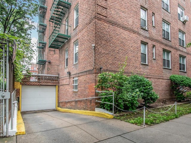 1425 Thieriot Ave Unit 2J, Bronx, NY 10460 - view of property featuring concrete driveway, an attached garage, and cooling unit